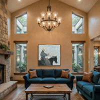 Living room with blue couch, wooden coffee table, and large windows. Hanging on the wall between the windows is a large-scale print of a modern west cowboy.