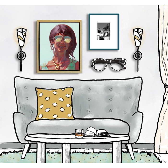 Living room with a gray sofa, yellow pillow, framed picture of a woman, and decorative elements.